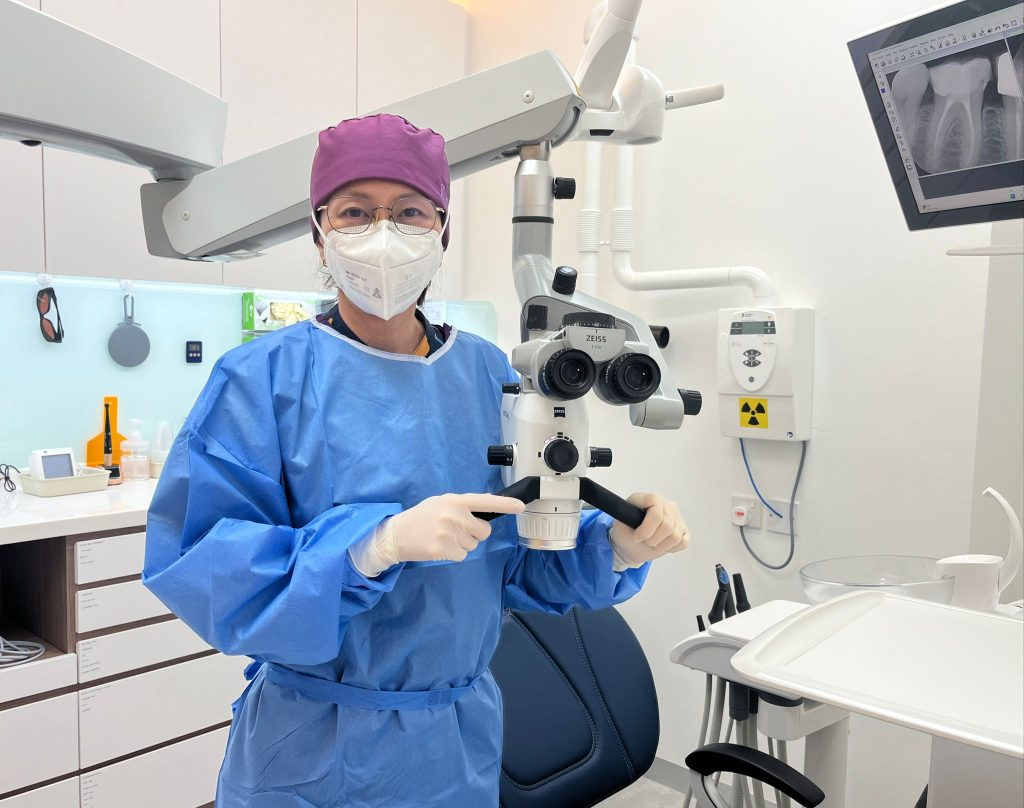 Dr Josephine with a dental operating microscope at Aster Dental.